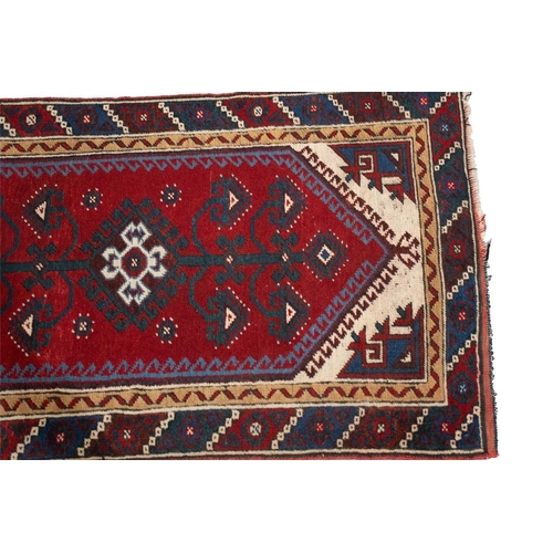 216 - A red ground Turkoman rug with rows of composite guls within reciprocal arrow head borders, 172 cm x... 