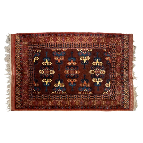 216 - A red ground Turkoman rug with rows of composite guls within reciprocal arrow head borders, 172 cm x... 