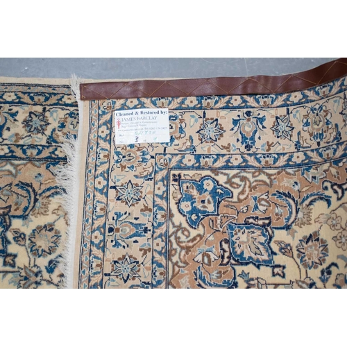 217 - An ivory ground Nain rug with formal bookcover design, within palmette borders. 191 cm x 121 cm A pr... 