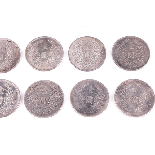 27 - A collection of eight Chinese silver 1914, one dollar (Fat-Man) coins, 4 cm diameter, together with ... 