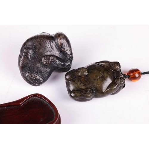 28 - A Chinese dark green jade toggle in the form of a corpulent tiger thought to be Tang Dynasty, (618 A... 