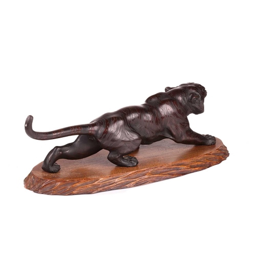 3 - A Japanese bronze okimono of a stalking tiger, first half of the 20th century, with inset glass eyes... 