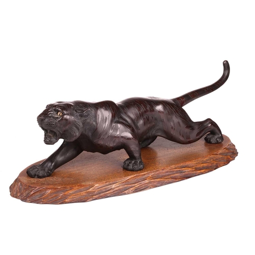 3 - A Japanese bronze okimono of a stalking tiger, first half of the 20th century, with inset glass eyes... 