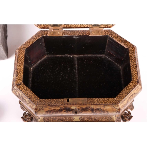 32 - A Chinese black lacquer ogee moulded two-section tea caddy, c.1800, painted with gilt Oriental lands... 