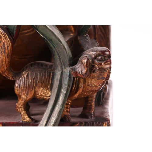 35 - A large pair of Chinese red lacquered and parcel-gilt wood architectural Dog of Foo finials, probabl... 