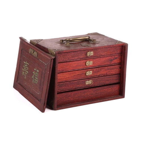 42 - A Chinese rosewood-cased mahjong set with bone and bamboo tiles the sliding door bearing the word Ma... 