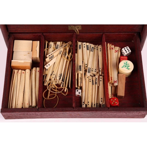 42 - A Chinese rosewood-cased mahjong set with bone and bamboo tiles the sliding door bearing the word Ma... 