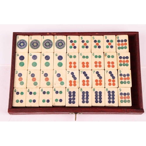 42 - A Chinese rosewood-cased mahjong set with bone and bamboo tiles the sliding door bearing the word Ma... 