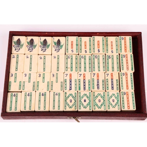 42 - A Chinese rosewood-cased mahjong set with bone and bamboo tiles the sliding door bearing the word Ma... 