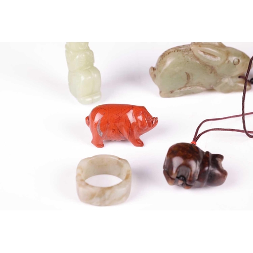 47 - A small collection of Chinese carved jade items including a celadon jade archer's ring, a small red ... 