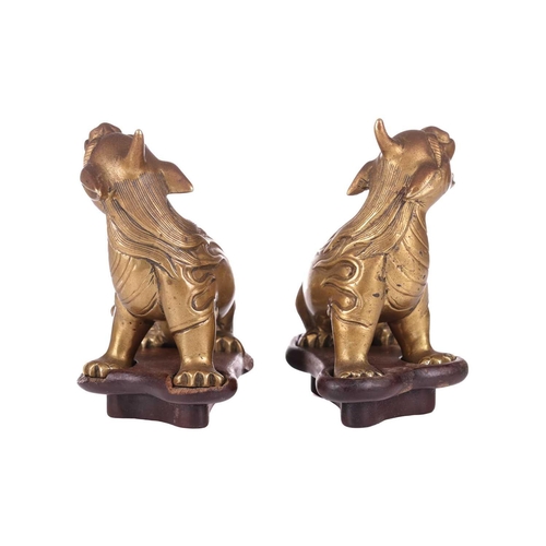 49 - A pair of Chinese, gilt bronze scholar's scroll weights, in the form of seated Pixue, Qing Dynasty, ... 