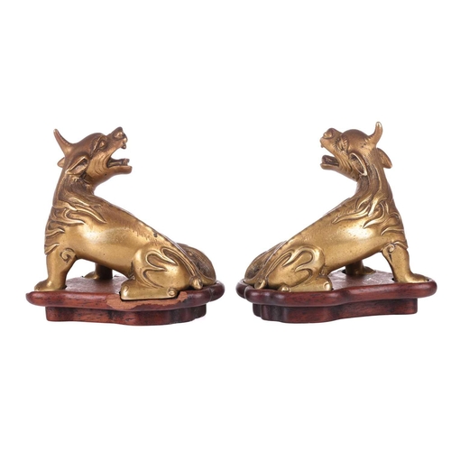 49 - A pair of Chinese, gilt bronze scholar's scroll weights, in the form of seated Pixue, Qing Dynasty, ... 