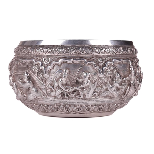 5 - A 19th-century Burmese silver circular bowl, finely embossed in high relief with figures preparing t... 