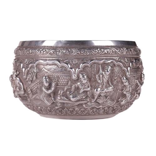 5 - A 19th-century Burmese silver circular bowl, finely embossed in high relief with figures preparing t... 