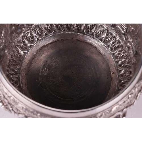 5 - A 19th-century Burmese silver circular bowl, finely embossed in high relief with figures preparing t... 