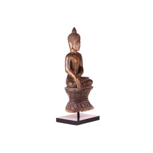 54 - A Siamese carved and giltwood, seated Buddha in Bhumisparsha, 18th century, with flame ushnisha, wit... 