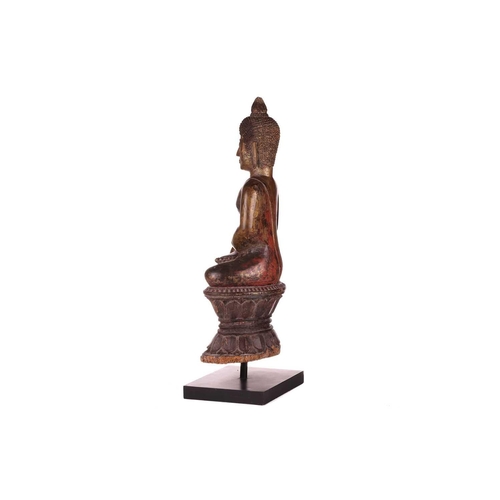 54 - A Siamese carved and giltwood, seated Buddha in Bhumisparsha, 18th century, with flame ushnisha, wit... 