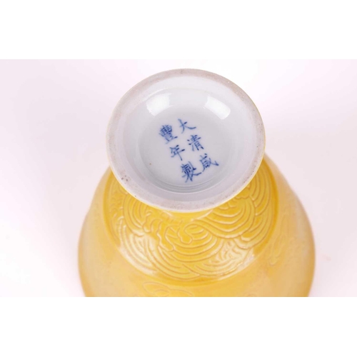 65 - A pair of Chinese yellow ground porcelain stem cups bearing a six-character mark for Guangxu (1875-1... 