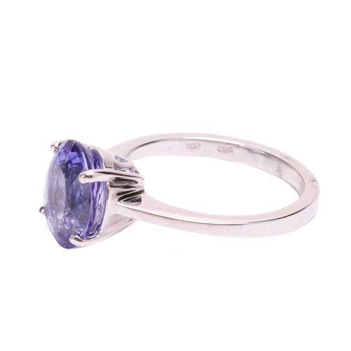 105 - A tanzanite single stone ring, set with an oval shape tanzanite measuring 10.3 x 8.3 x 5.2mm, in a c... 