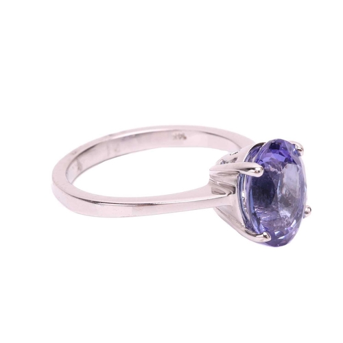 105 - A tanzanite single stone ring, set with an oval shape tanzanite measuring 10.3 x 8.3 x 5.2mm, in a c... 