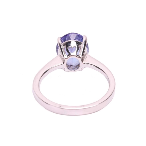 105 - A tanzanite single stone ring, set with an oval shape tanzanite measuring 10.3 x 8.3 x 5.2mm, in a c... 