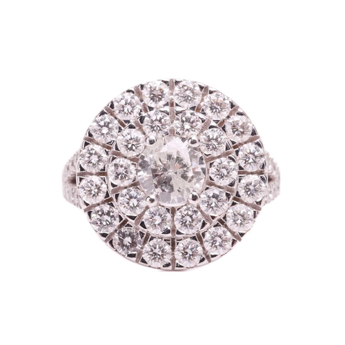 108 - A diamond cluster ring, featuring a central round brilliant cut diamond with an estimated weight of ... 