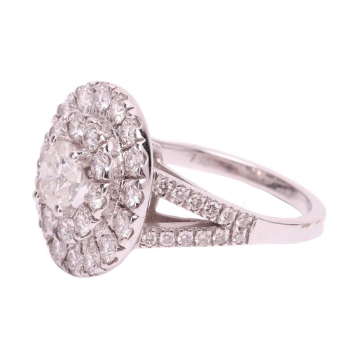 108 - A diamond cluster ring, featuring a central round brilliant cut diamond with an estimated weight of ... 