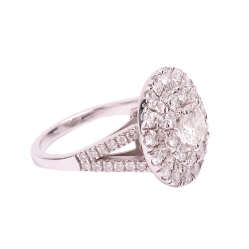 108 - A diamond cluster ring, featuring a central round brilliant cut diamond with an estimated weight of ... 