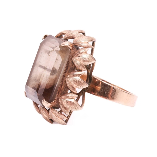 119 - A large smoky quartz dress ring, centred with a large octagonal step-cut smoky quartz of 19.8 x 15.2... 