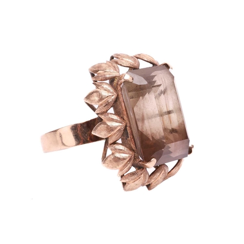 119 - A large smoky quartz dress ring, centred with a large octagonal step-cut smoky quartz of 19.8 x 15.2... 