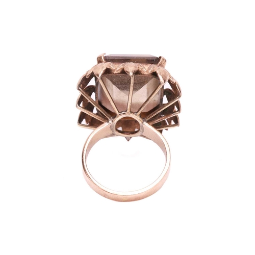 119 - A large smoky quartz dress ring, centred with a large octagonal step-cut smoky quartz of 19.8 x 15.2... 