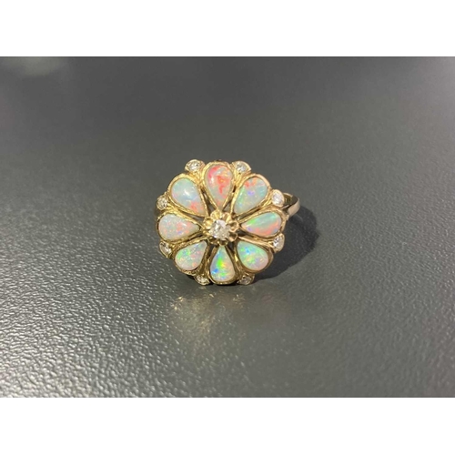 12 - An opal and diamond floral cluster ring, comprising eight pear-shaped precious opal cabochons formin... 