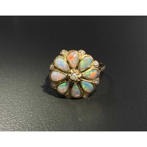 12 - An opal and diamond floral cluster ring, comprising eight pear-shaped precious opal cabochons formin... 