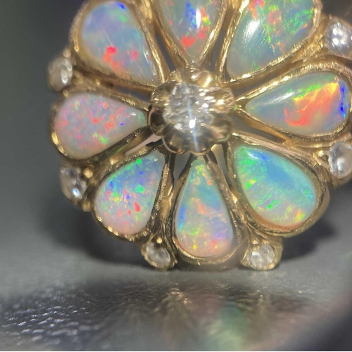 12 - An opal and diamond floral cluster ring, comprising eight pear-shaped precious opal cabochons formin... 