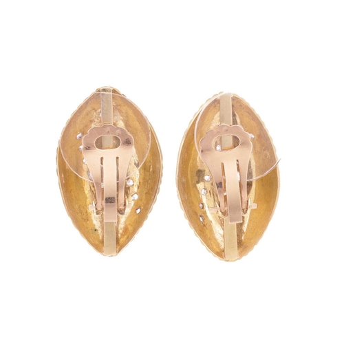 132 - A pair of earrings set with old-cut diamonds, of ridged seashell form, highlighted with two lines of... 