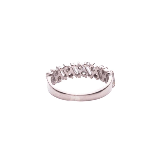 133 - A half-eternity diamond-set ring, claw set with pairs of round brilliant diamonds between baguette-c... 