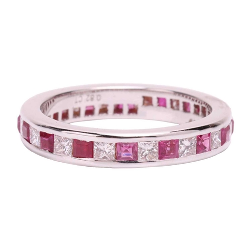 139 - A ruby and diamond eternity ring, set with a continuous row of alternating square step cut synthetic... 