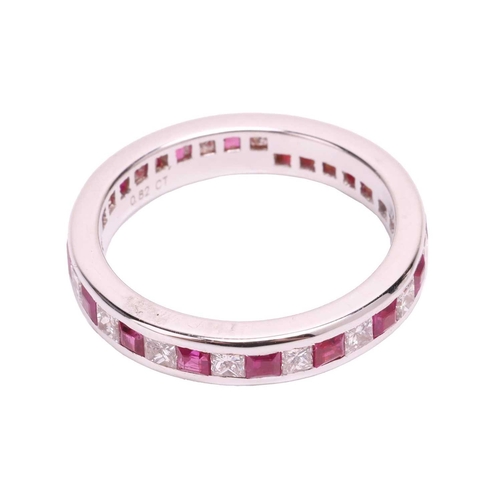 139 - A ruby and diamond eternity ring, set with a continuous row of alternating square step cut synthetic... 