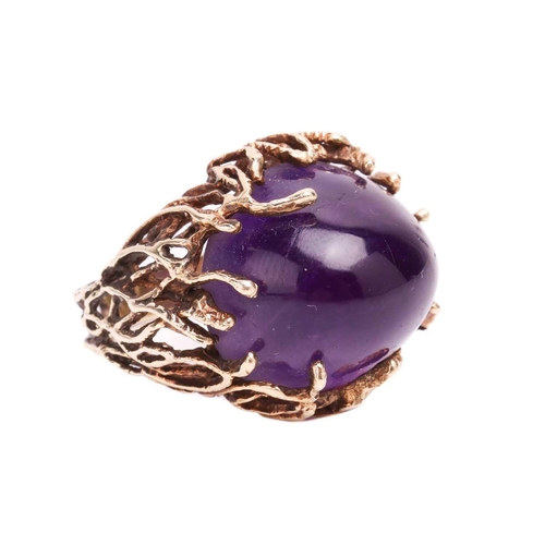 141 - A Modernist amethyst cocktail ring, featuring a large and high-domed amethyst of 19.8 x 17.3 x 13.9 ... 