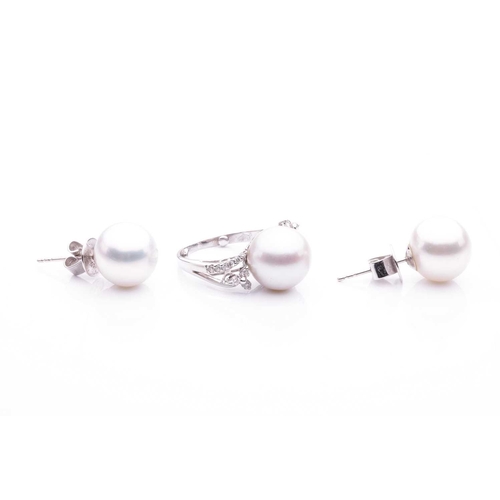 143 - A cultured saltwater pearl dress ring and a pair of stud earrings; the dress ring features a large a... 