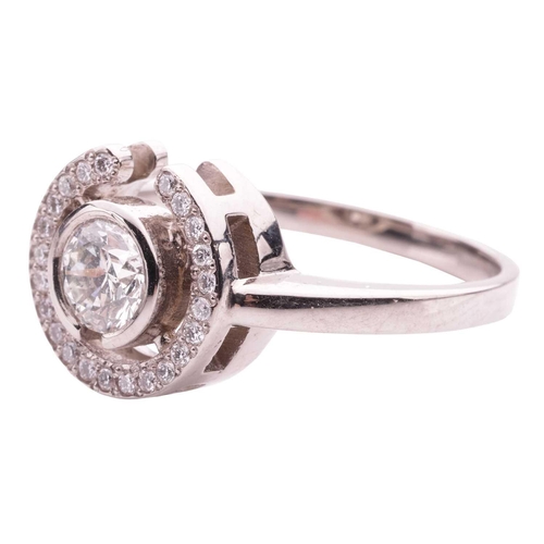 154 - A diamond halo ring, collet-set with a round brilliant-cut diamond of 0.50ct, encircled with a frame... 