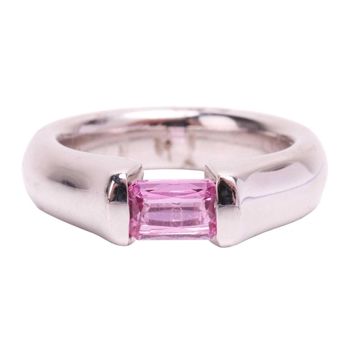 155 - A pink sapphire dress ring, containing an octagonal scissor-cut pink sapphire of 5.5 x 4.0 mm, bar-s... 