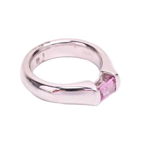 155 - A pink sapphire dress ring, containing an octagonal scissor-cut pink sapphire of 5.5 x 4.0 mm, bar-s... 