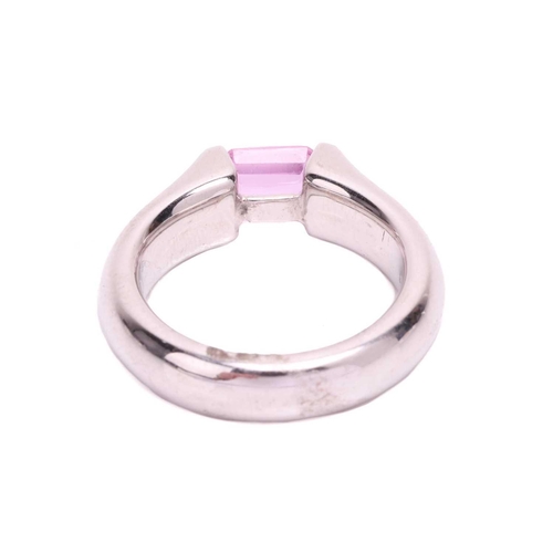 155 - A pink sapphire dress ring, containing an octagonal scissor-cut pink sapphire of 5.5 x 4.0 mm, bar-s... 