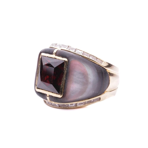 16 - A gem-set cocktail ring, centred with a square scissors-cut garnet in collet, shoulders inlaid with ... 