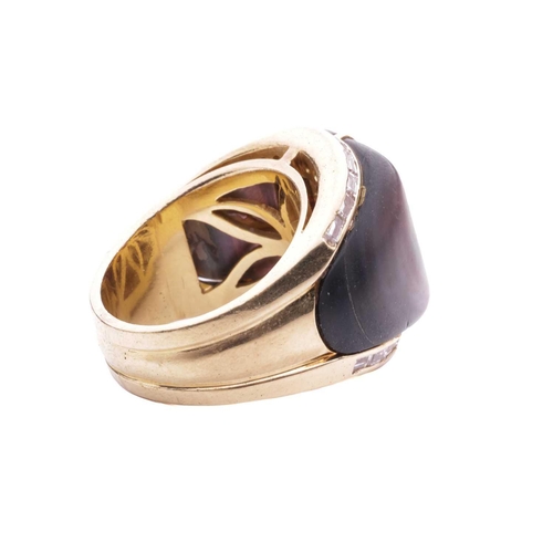 16 - A gem-set cocktail ring, centred with a square scissors-cut garnet in collet, shoulders inlaid with ... 