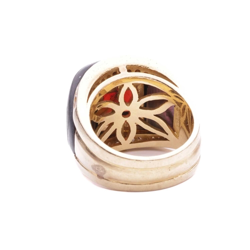 16 - A gem-set cocktail ring, centred with a square scissors-cut garnet in collet, shoulders inlaid with ... 