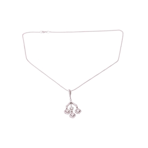 160 - A diamond pendant in a chandelier design with a triple drop, each drop featuring a square emerald cu... 