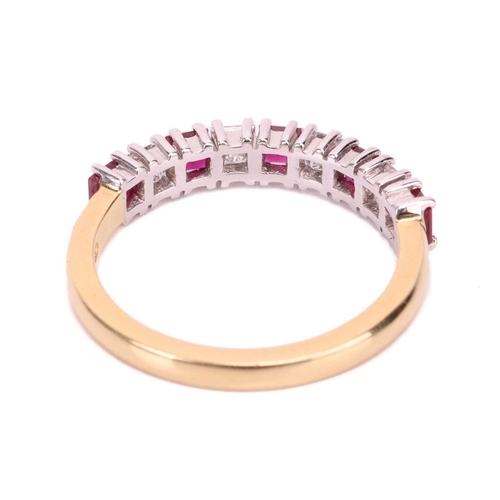 163 - A ruby and diamond half-eternity ring in 18ct gold, comprising princess-cut rubies with an estimated... 