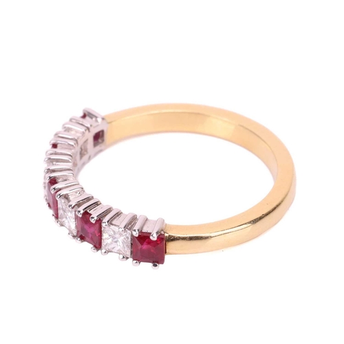 163 - A ruby and diamond half-eternity ring in 18ct gold, comprising princess-cut rubies with an estimated... 